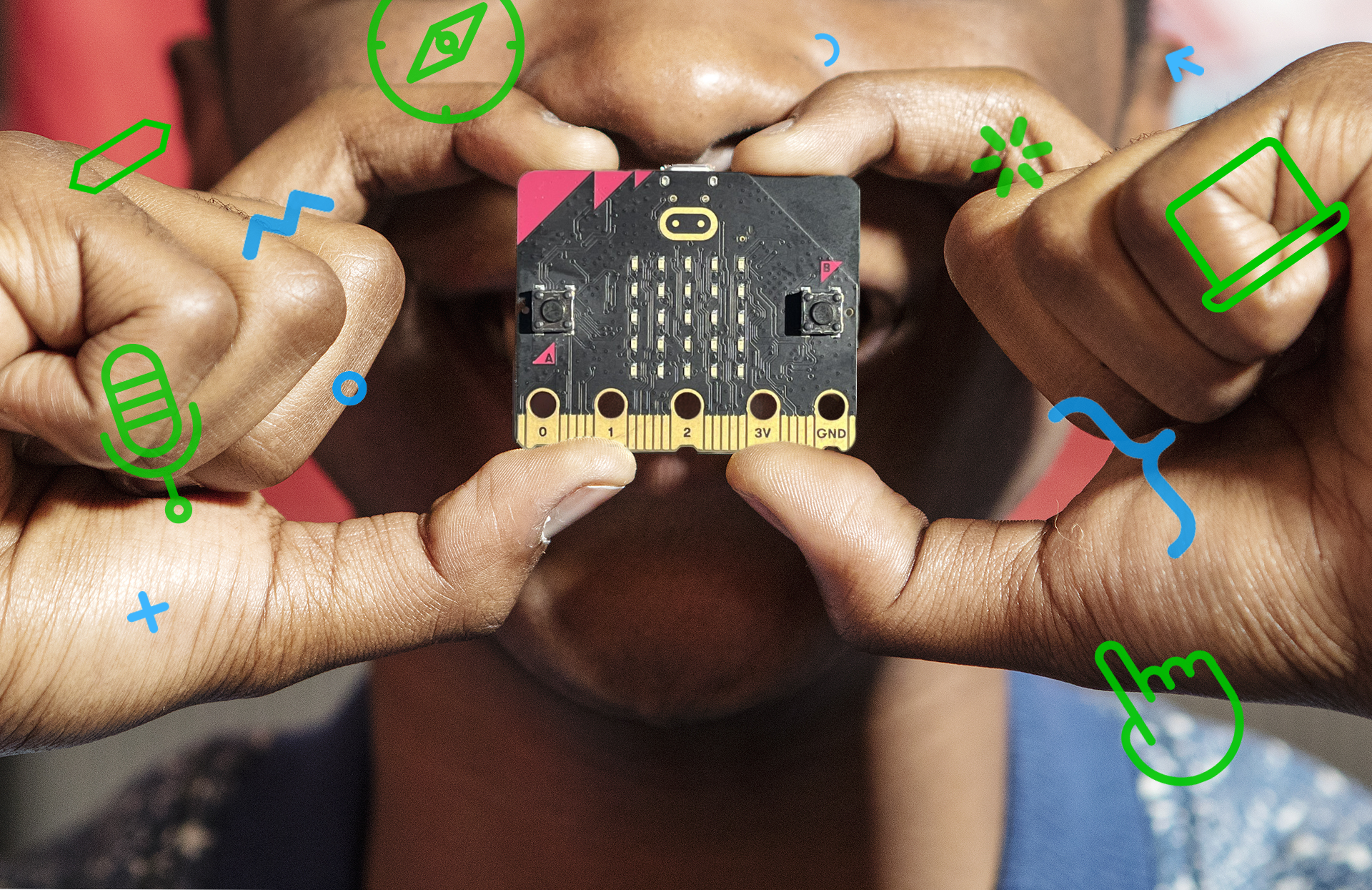 close-up photo of a child holding a micro:bit board between their fingers over their face
